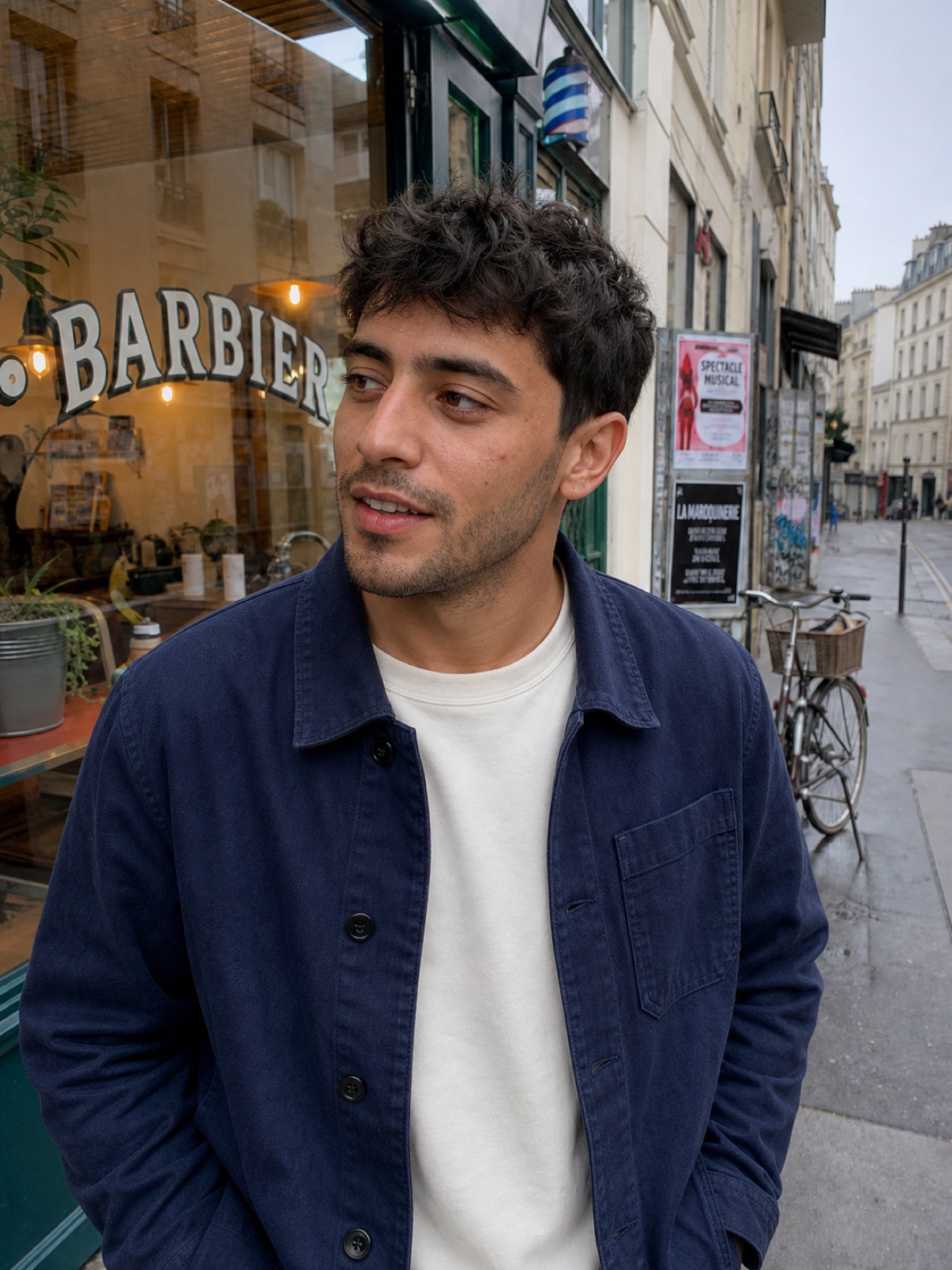 Young French man photographed outside a Paris barbershop